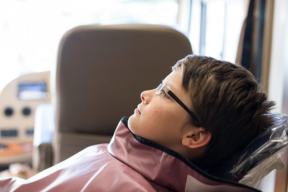 Julian Gervais, 11, waits for an x-ray inside the SMILEmobile